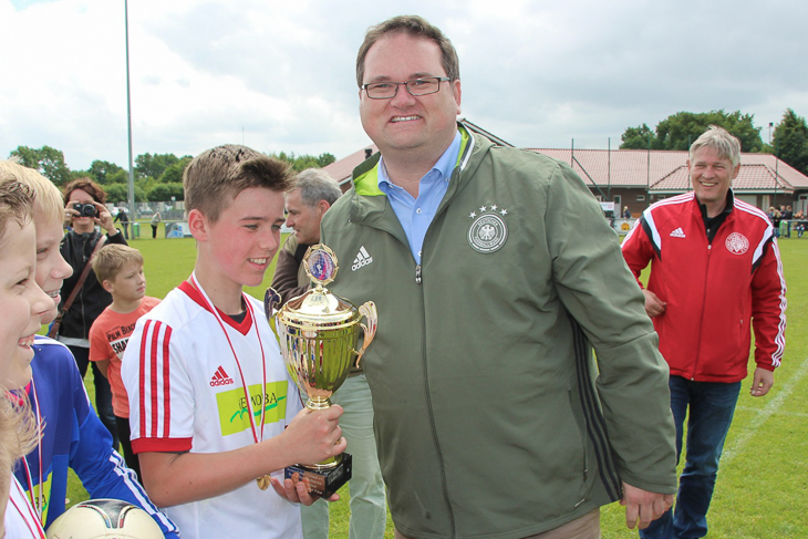 BFV-Präsident Björn Fecker (r.) übergab den Pokal an die D-Junioren des SC Lehe-Spaden.